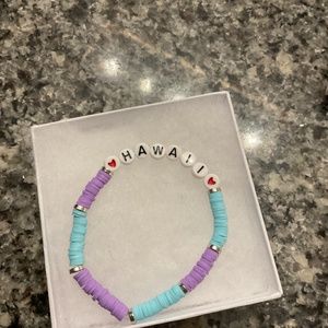 Bracelets they are end size and this is purple and blue and says Hawaii